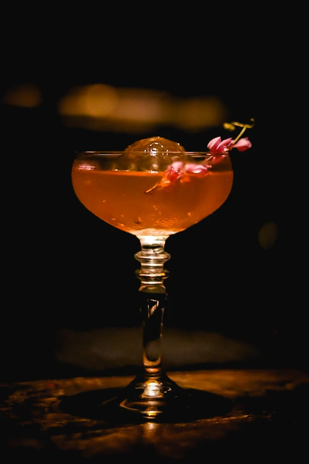 A flower-garnished cocktail on the Root Bar counter