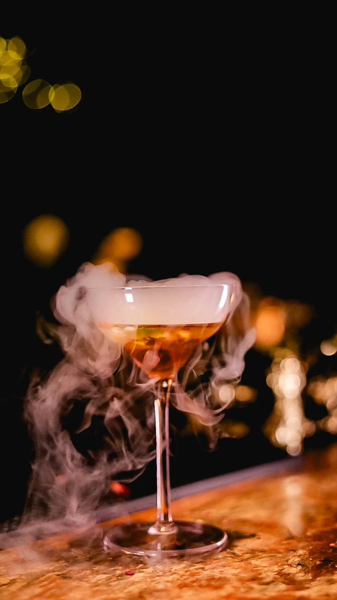 A cocktail presented with a delicate cloud of smoke