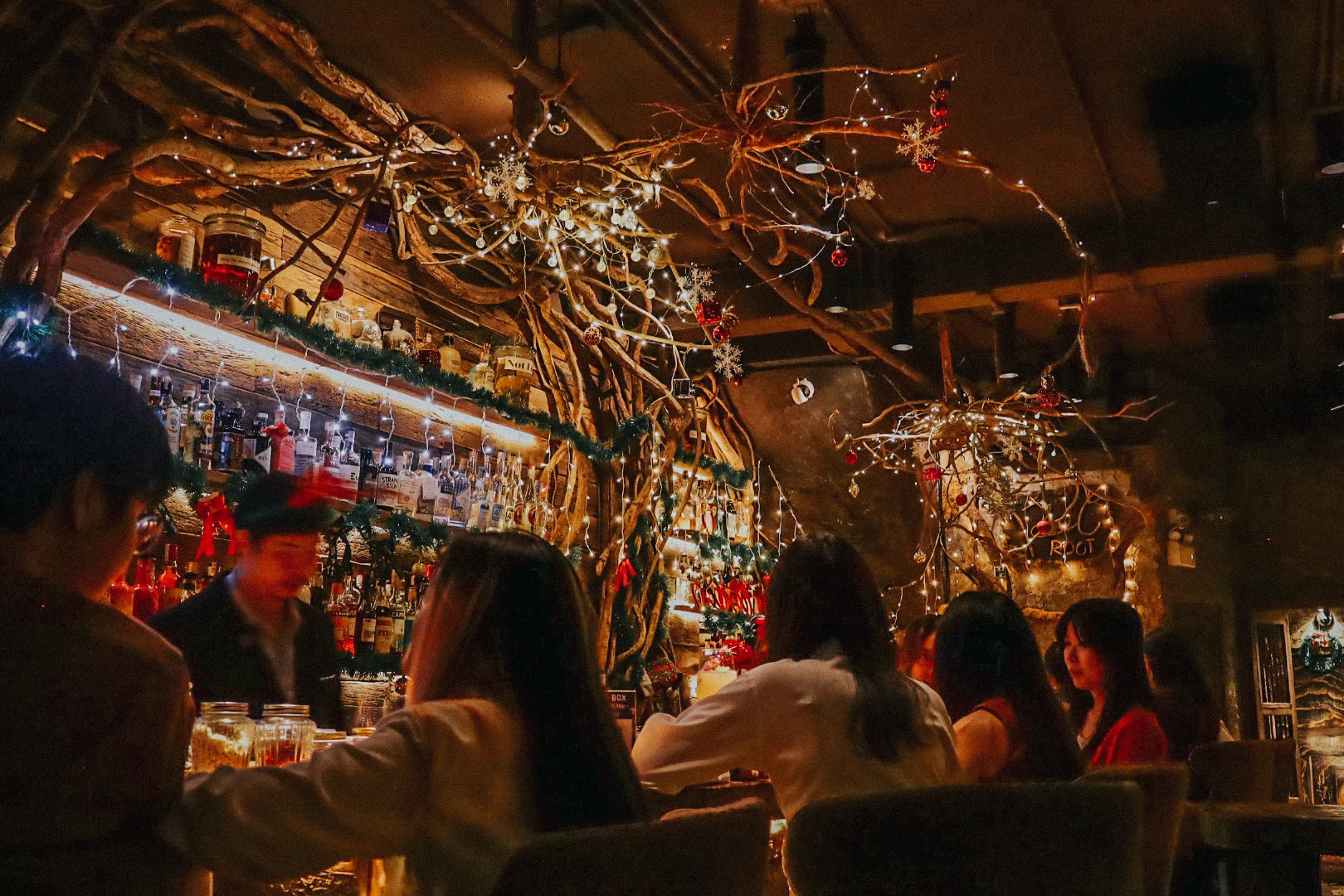 Guests gathered around the warmly lit Root Bar counter