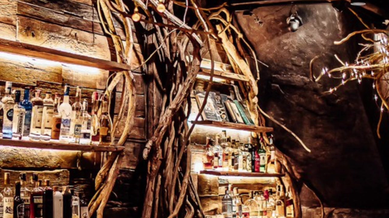 The warmly lit interior and intimate seating at Root Bar Bangkok